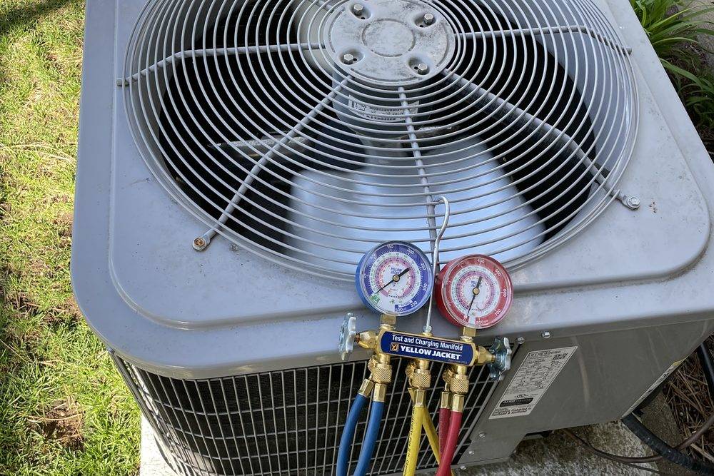 Manifold gauges connected to an outdoor air conditioner