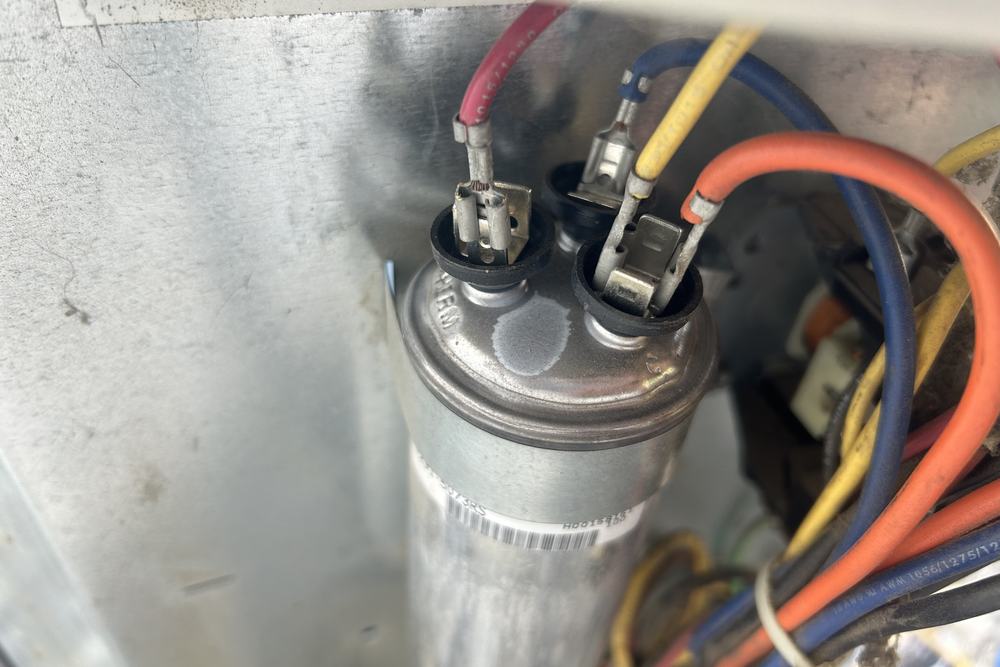 Capacitor and wiring inside a heat pump control panel
