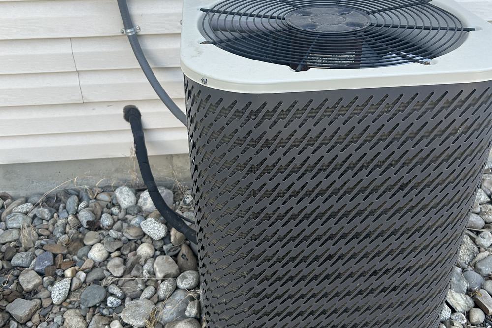 Outdoor unit installed on a pad with the disconnect on the wall