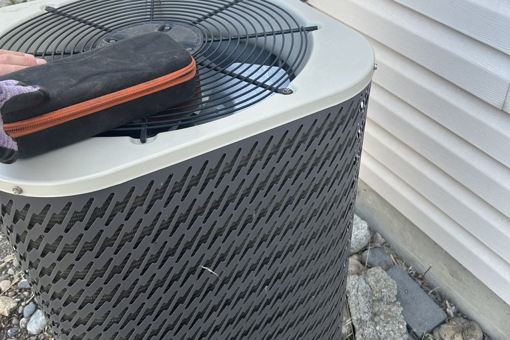 Top view of an outdoor condensing unit beside a house