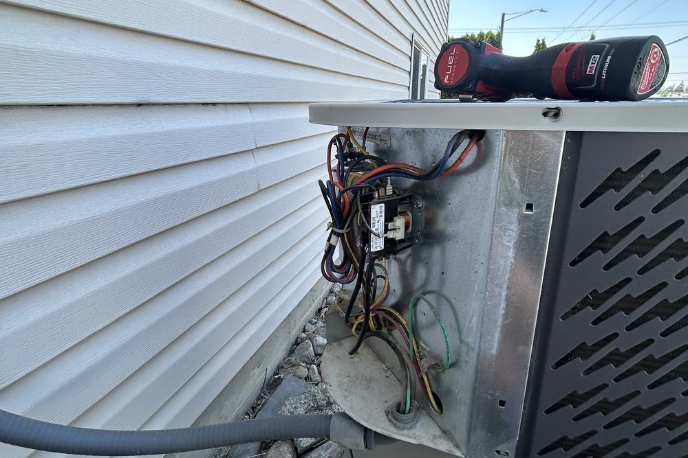 Contactor and wiring inside an open condenser panel
