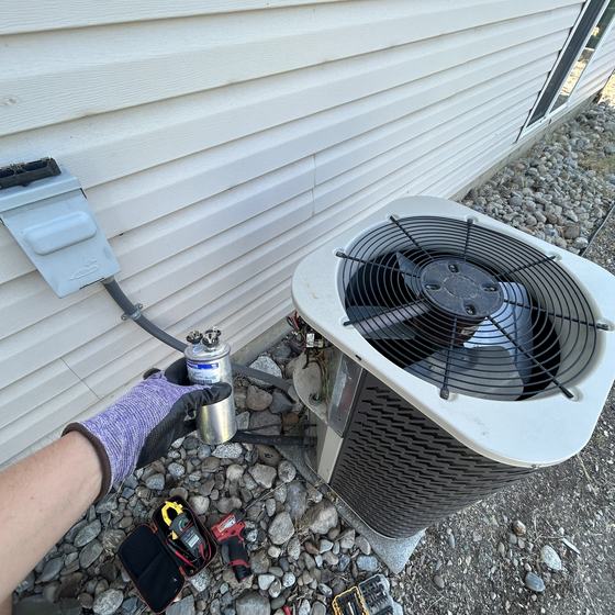 Genry HVAC technician working on an outdoor unit