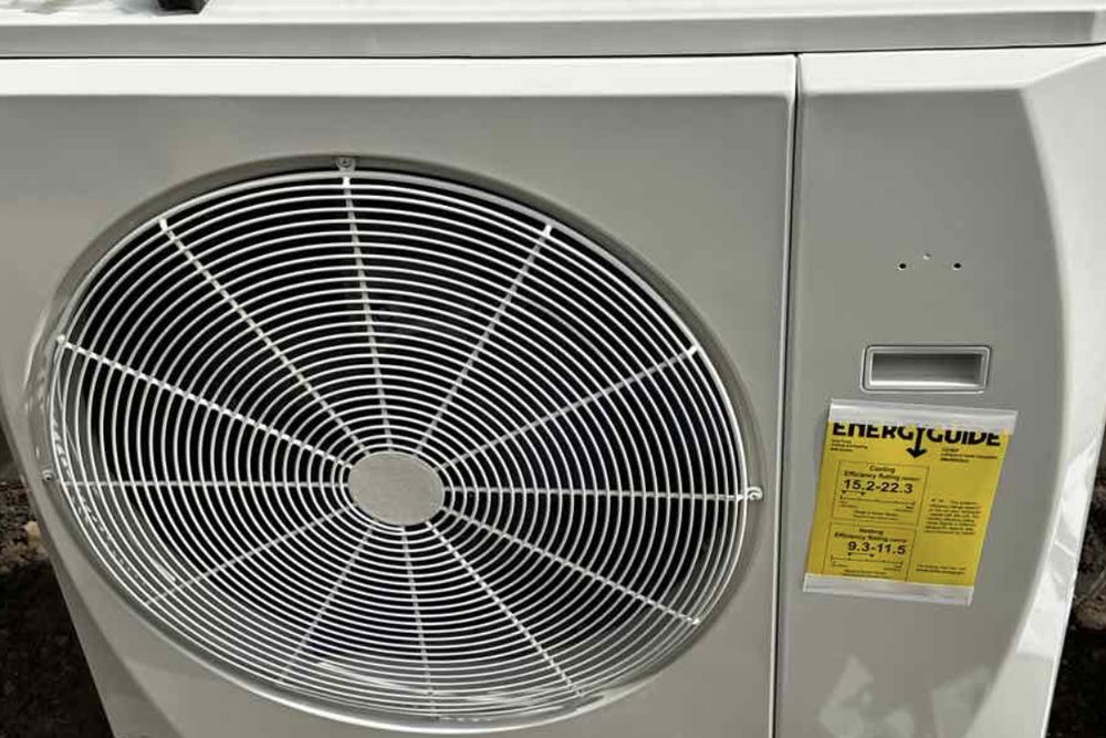 Ductless mini-split outdoor unit against a wall