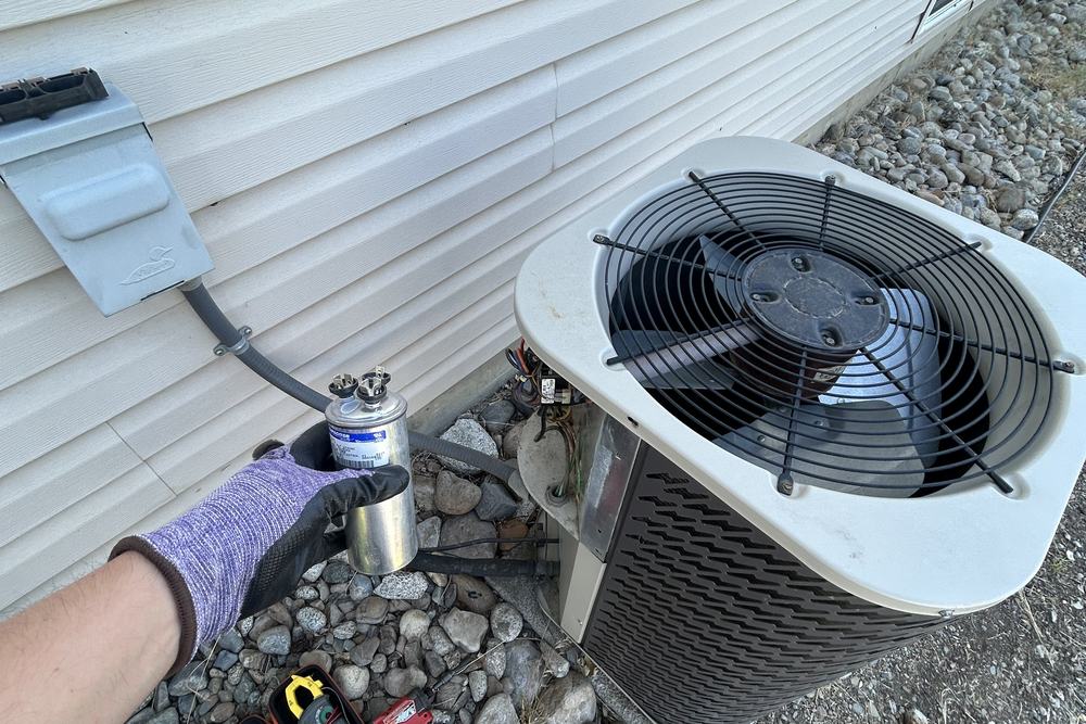 Tools laid out beside an outdoor unit during a job